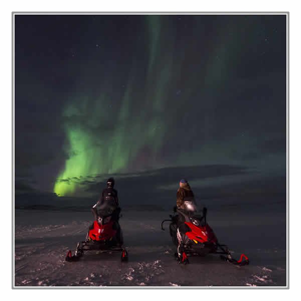 Snowmobiling under the Northern Lights